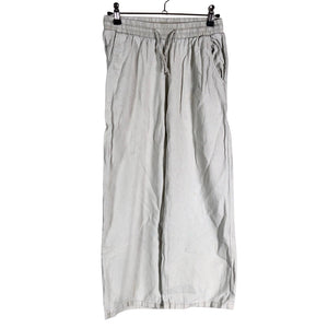 Unisex Lindex - Mittevenivad püksid, suurus 134 - 140 - Beige (1)