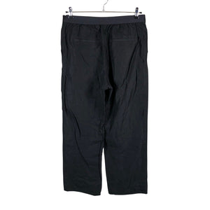 Unisex Arket - Mittevenivad püksid, suurus 42 - Must (2)