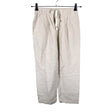 Unisex Uniqlo - Mittevenivad püksid, suurus 34 - Beige ()