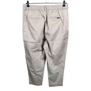 Unisex Noom - Mittevenivad poolpikad püksid, suurus 42 - Beige (2)