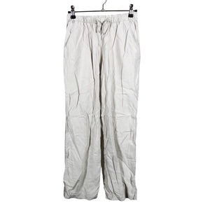 Unisex Lindex - Mittevenivad püksid, suurus 140 - 146 - Beige (1)