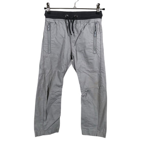 Unisex Next - Mittevenivad püksid, suurus 104 - 110 - Hall (1)