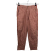Unisex Uniqlo - Mittevenivad püksid, suurus 34 - Heleroosa ()